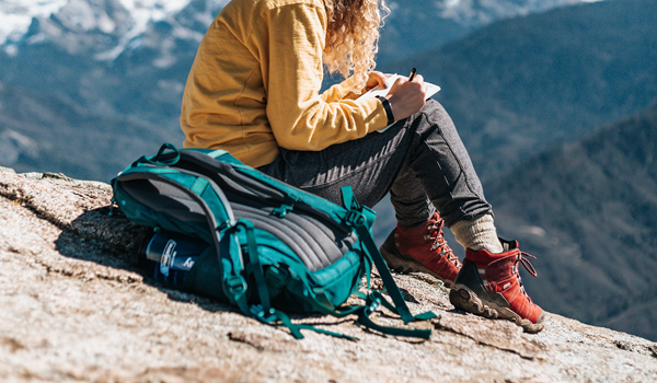 a person sitting on top of a mountain